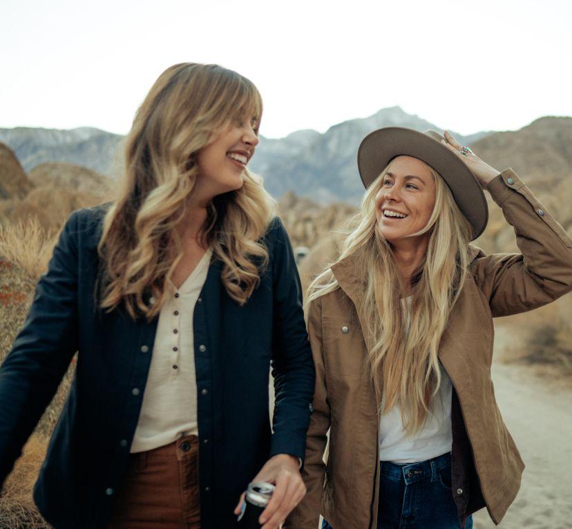 Two women having fun and wearing their Kühl Casual Jackets.