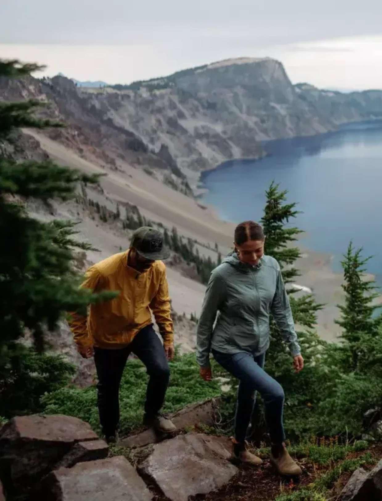 People wearing The One™ jackets with a lake in the background.