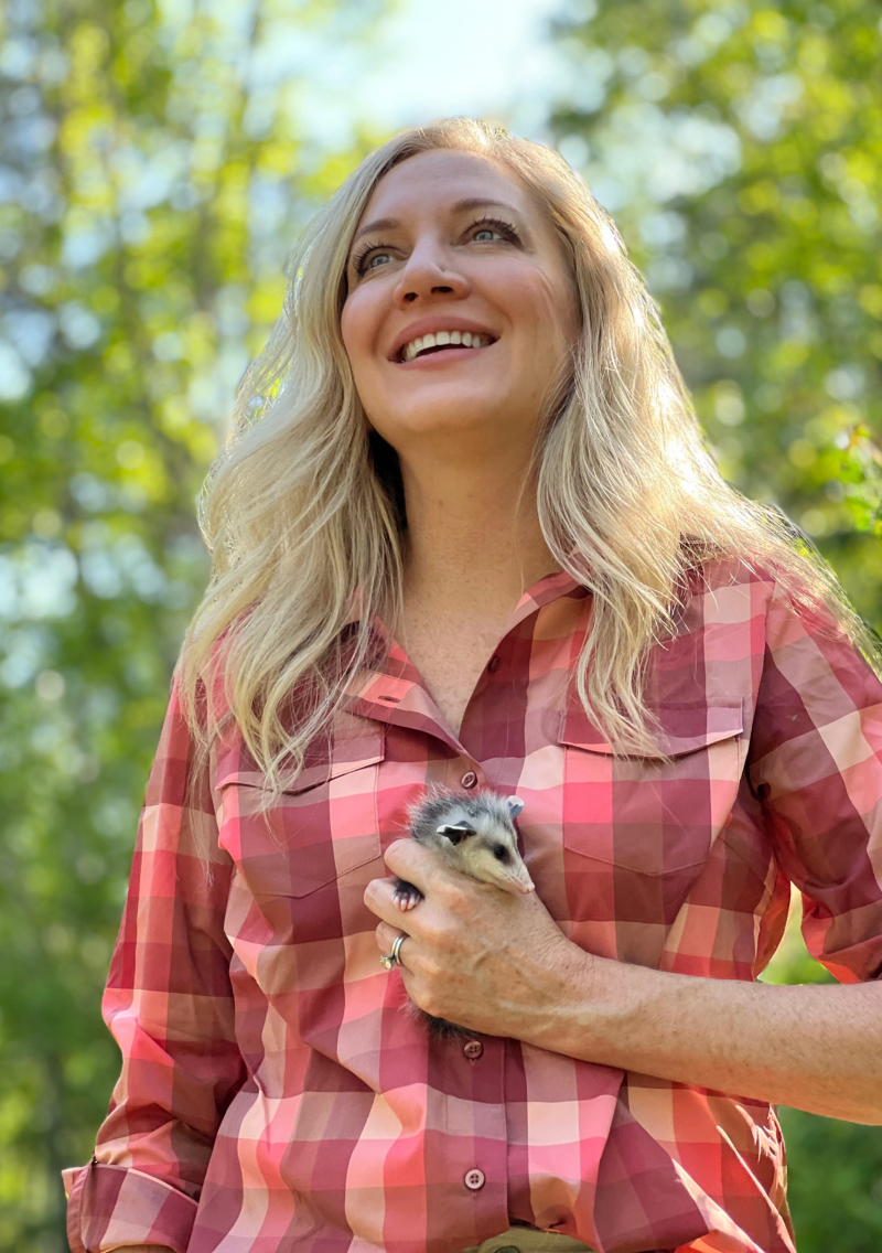 Laurie Hood holds a baby opossum at Alaqua Animal Refuge.