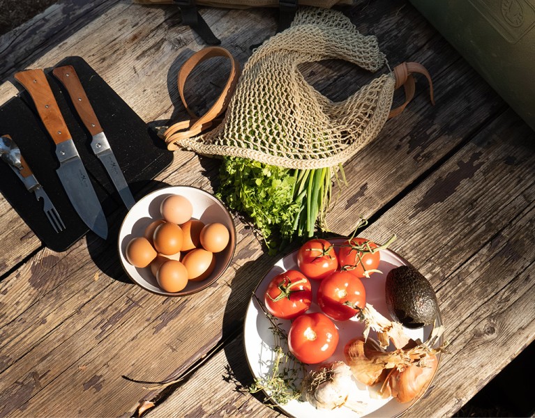Elevated camping cooking ingredients on a wooden table
