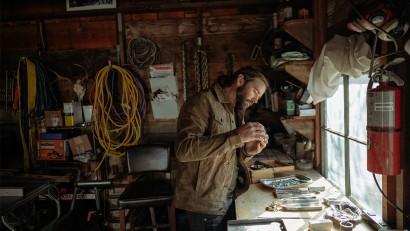Tobias Corwin making jewels in his workshop.