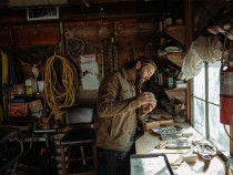 Tobias Corwin making jewels in his workshop.
