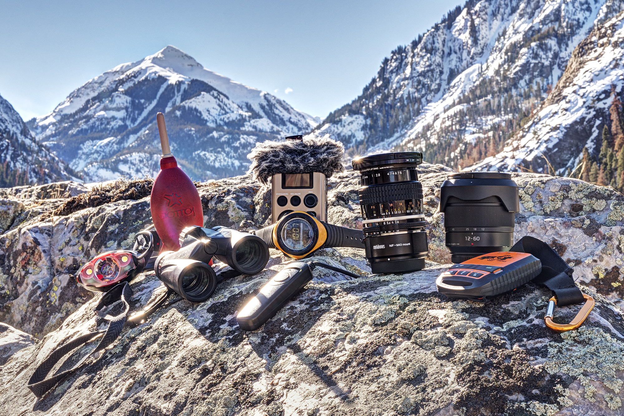 An image of winter hiking gear - clock, binoculus, lamp