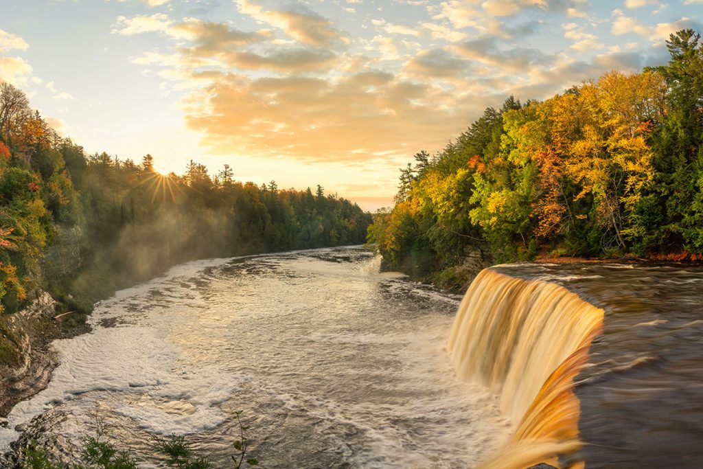 Sunrise shining on the Upper Tahquamenon Falls in Autumn