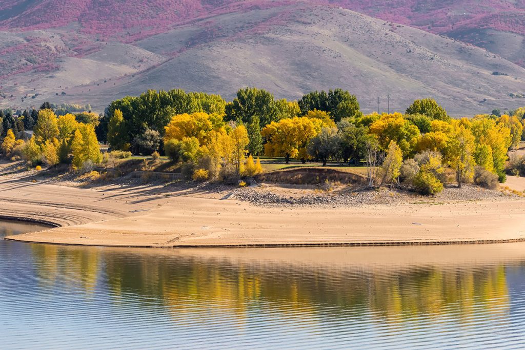 Panoramic view of colorful Cottonwood trees reflections at Pine view reservoir