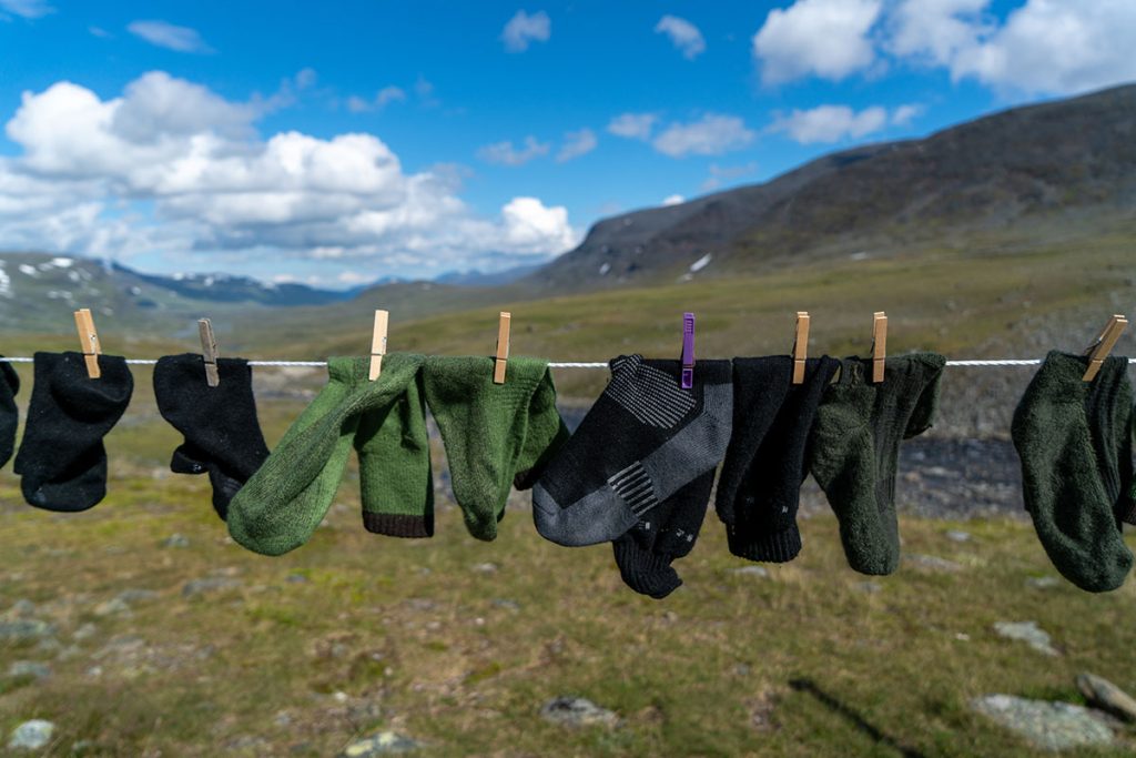 Wet socks hung to dry on a washing line when hiking & camping in the wilderness