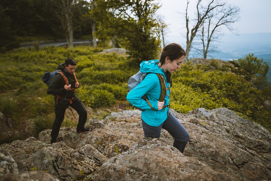 Indoorsy Partner to Outdoor Adventures - A man and a woman hiking in KUHL clothing.