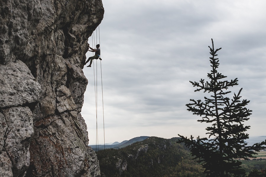 A man rock climbing in Kamouraska, Canada.