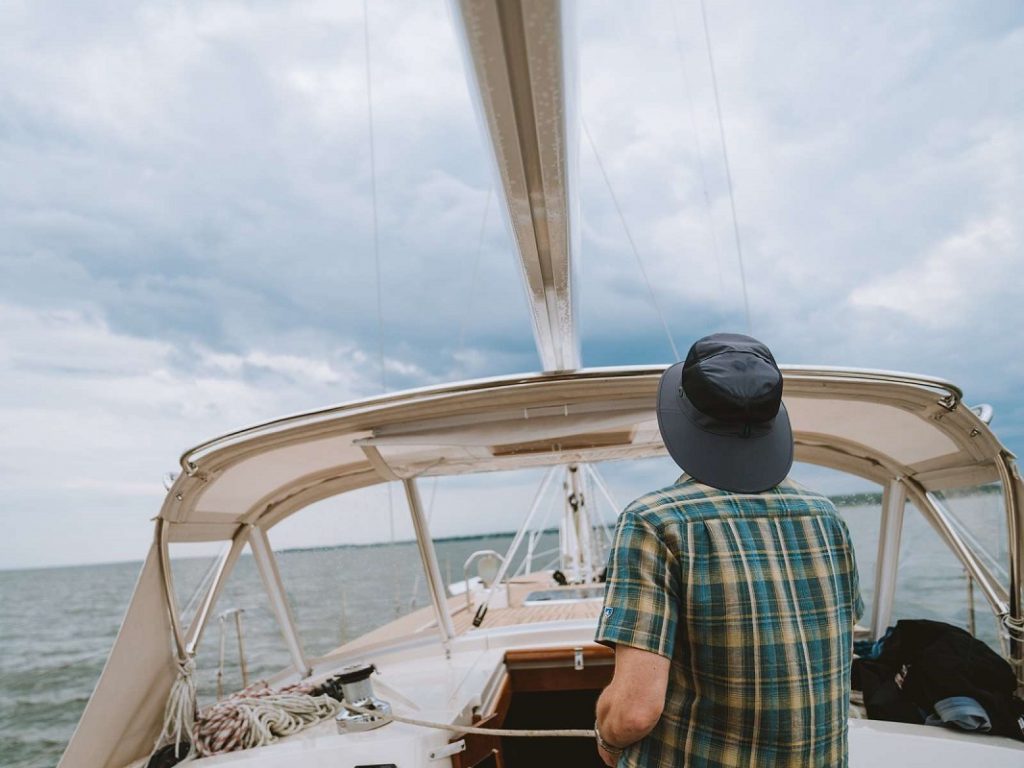 man with blue hat on boat