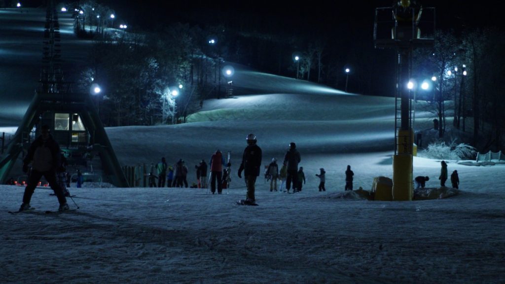 people on snowy ground at night
