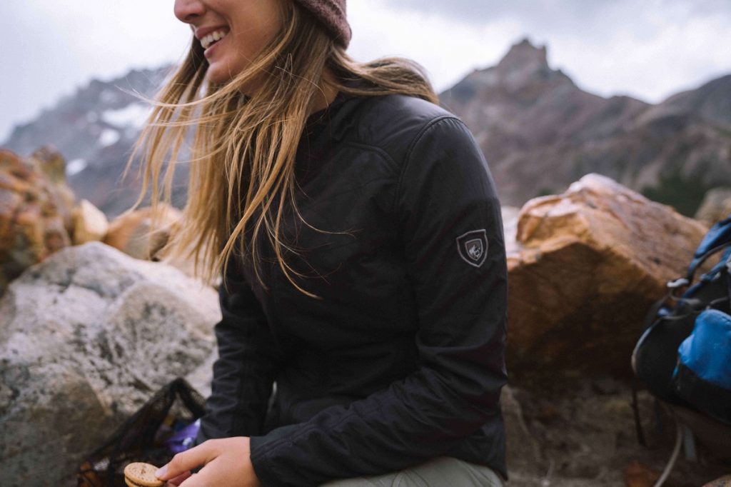 girl wearing K&Uuml;HL black jacket laughing outdoors