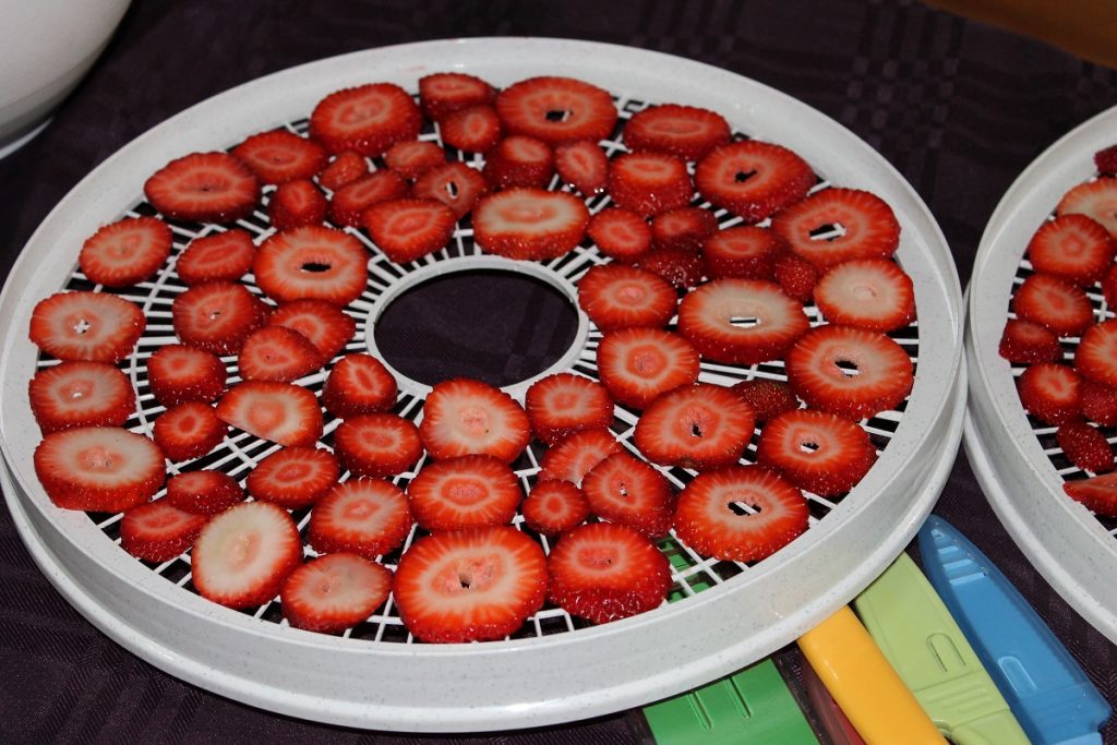 sliced red strawberries on white thin plate