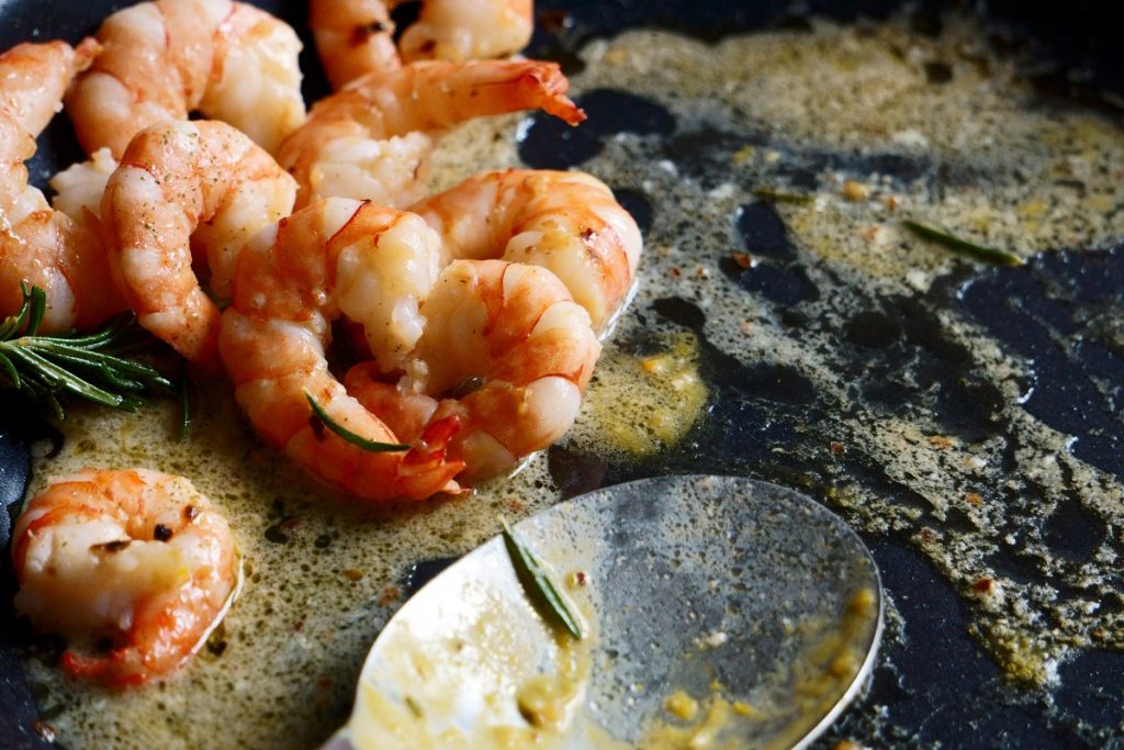 shrimps cooking on a black pan