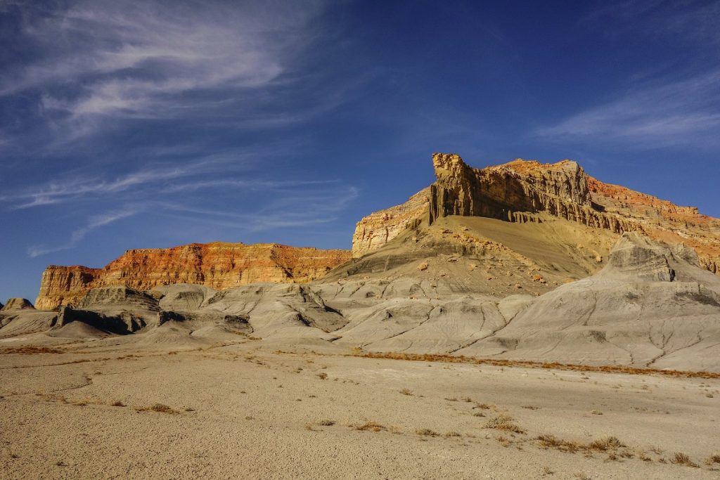 brown rock formations rising in desert
