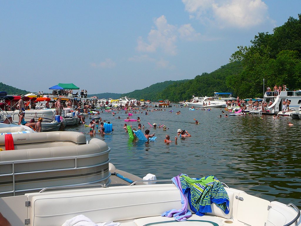 pontoon boats and people in body of water
