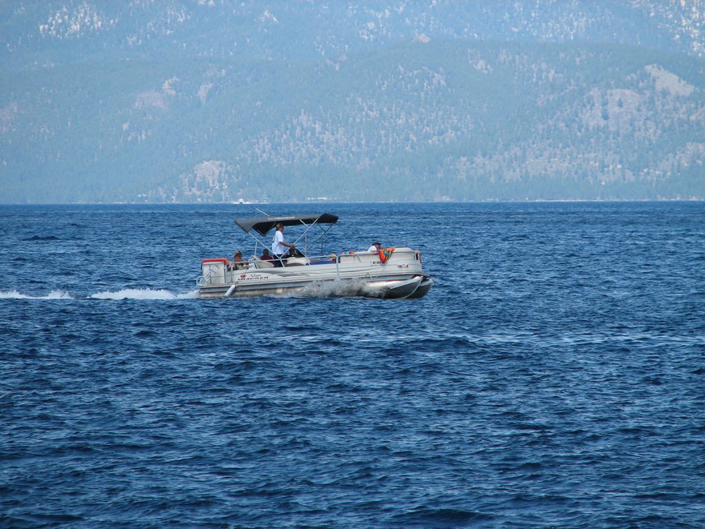 pontoon boat on body of water