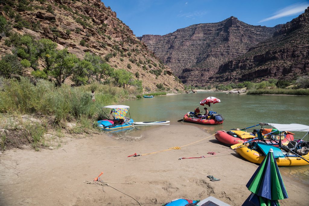 rafts on the water next to the coast in the canyon