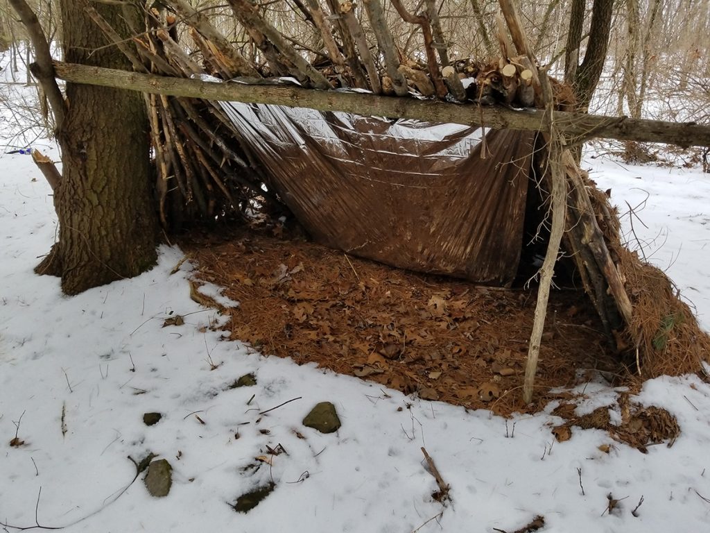 lean to survival shelter on snow