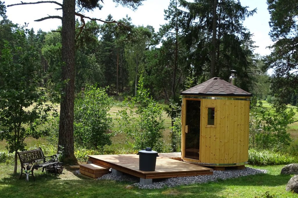 yellow wooden cabin sauna in the backyard