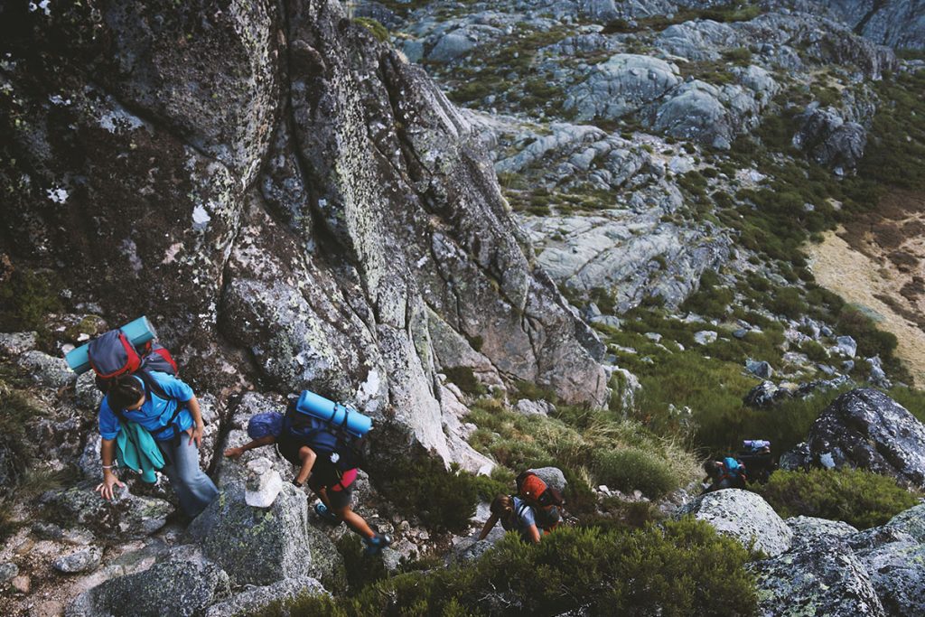 Several Mountain Climbers On Cliff Of a Rock Mountain