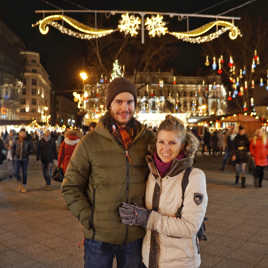KUHL Ambassador Nicole with a KUHL man standing in a winter decorated street in Budapest