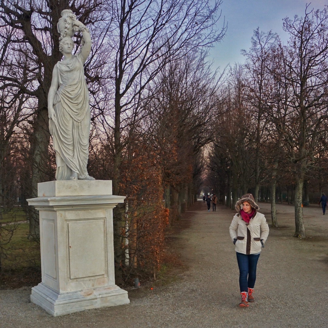KUHL Ambassador Nicole and standing in a park next to a statue.