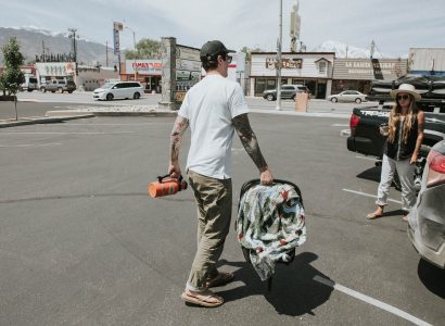 Dads Passion for Desert Hikes - Dad carrying a baby on a parking lot