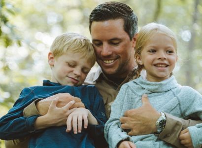 Have We Domesticated the Wild Child - A father and his children dressed in outdoor apparel