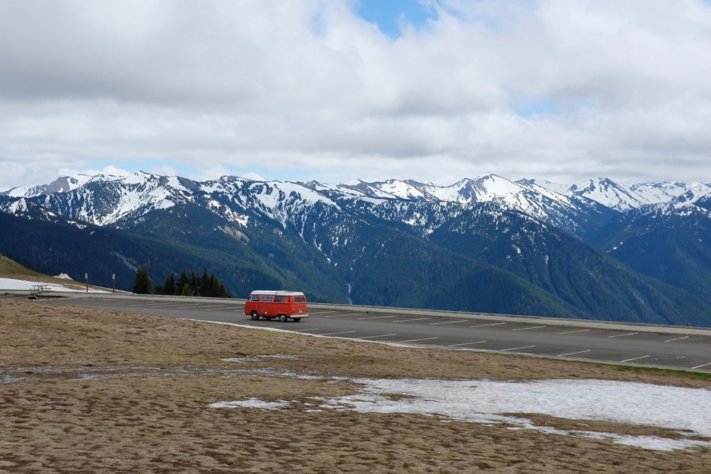 red RV on parking lot in mountains