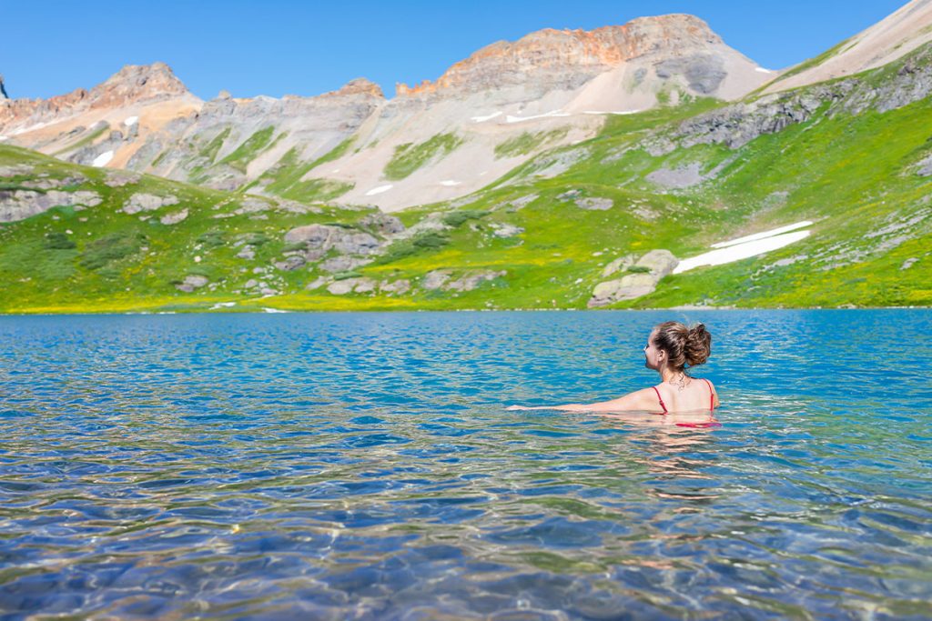 Young woman girl swimming cold colorful water