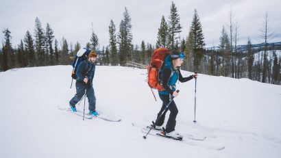 A man and a woman enjoying their winter hiking clothing