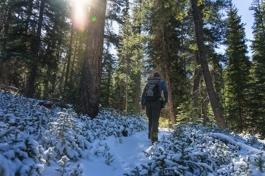 Natures Call What Drives Us to Explore - Lady walking in KUHL winter hiking clothes.