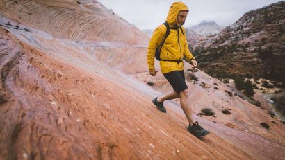 man in yellow jacket hiking