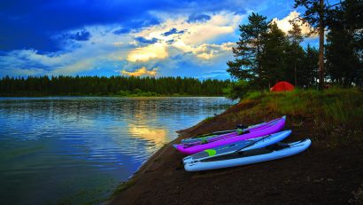 Storm clouds along Hebgen Lake with paddleboard and kayaks