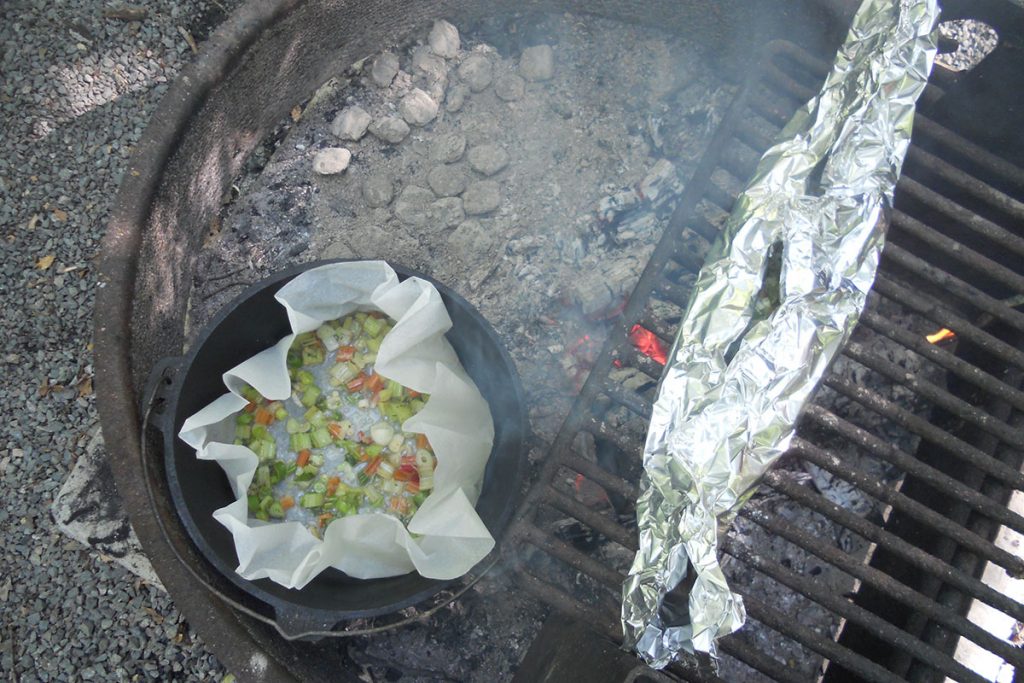 beans and fish in tin foil cooking on grill