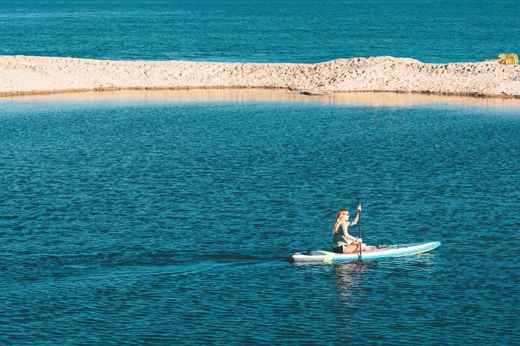 woman paddling on body of water