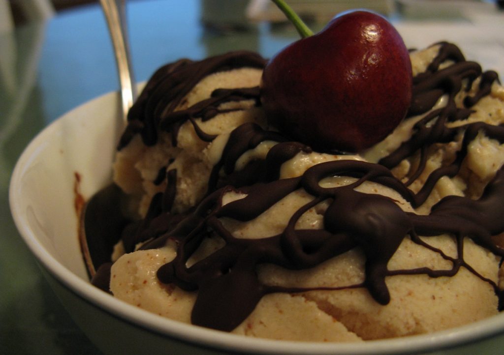 vegan ice cream with chocolate drizzle and cherry on top
