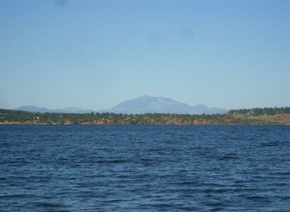 body of water with mountain peak in the back