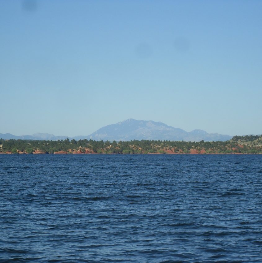 body of water with mountain peak in the back