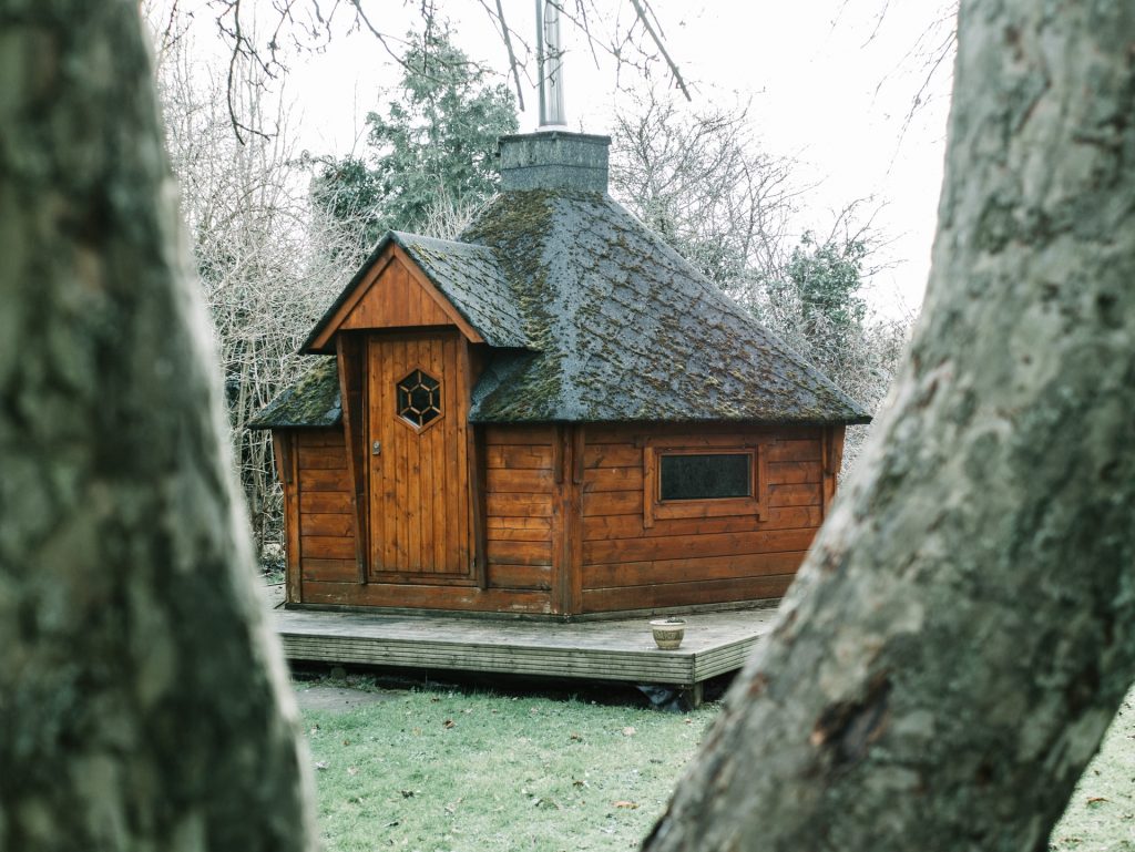 small brown sauna building in the outdoors