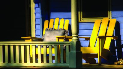 Two Yellow Adirondack Chairs on Porch