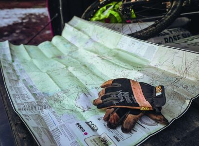 working gloves on a biking trail map