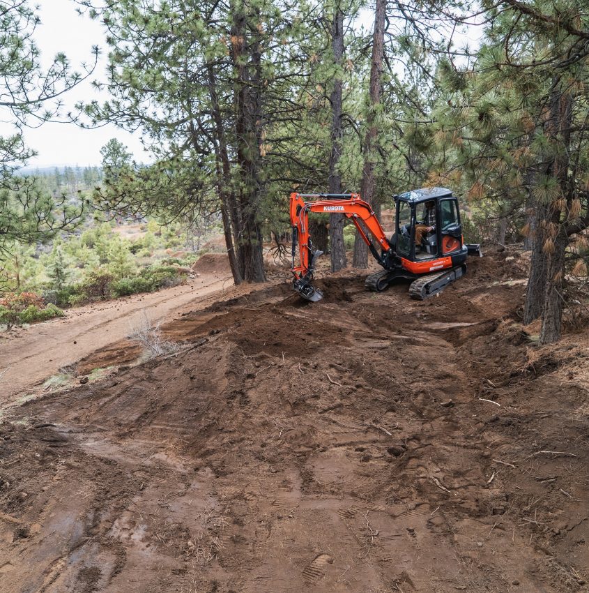 excavator setting up a trail to be built