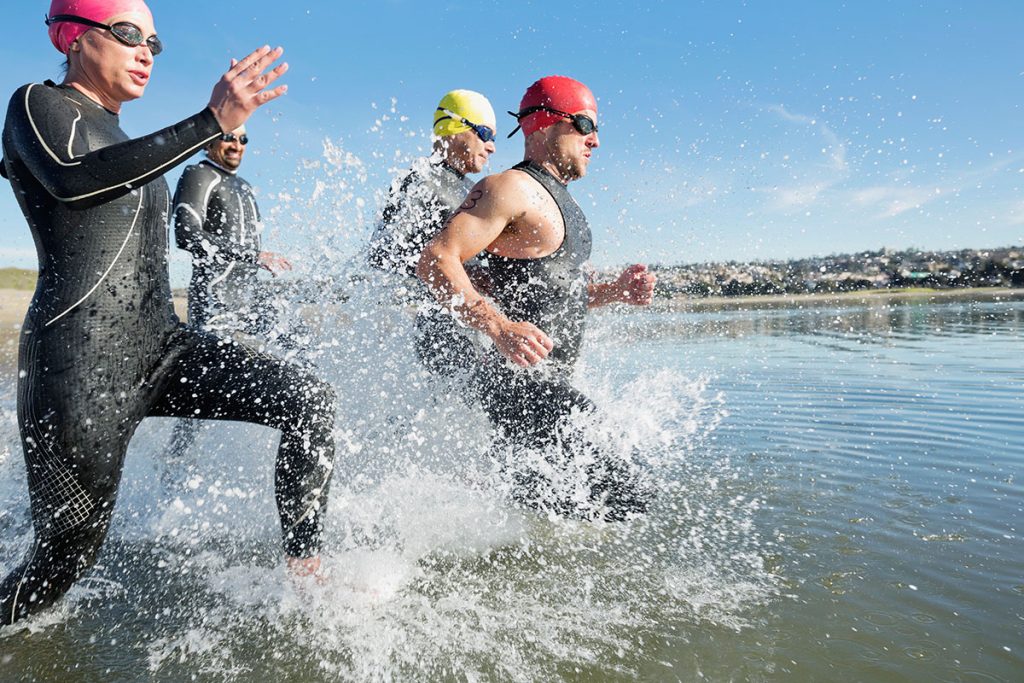 Triathletes running into water