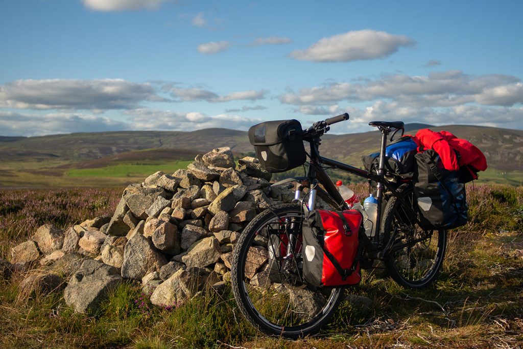 travel bike in the mountains. fully equipped with bags and cycling gear