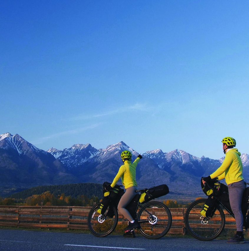 The man and woman travel on mixed terrain cycle touring with bikepacking