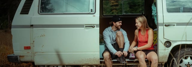 a group of friends on a porch wearing KÜHL clothing.