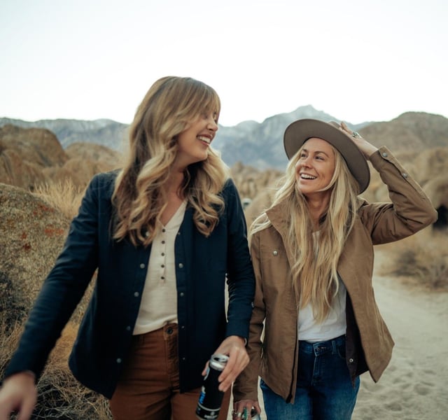 Two women having fun and wearing Kühl Casual Jackets.