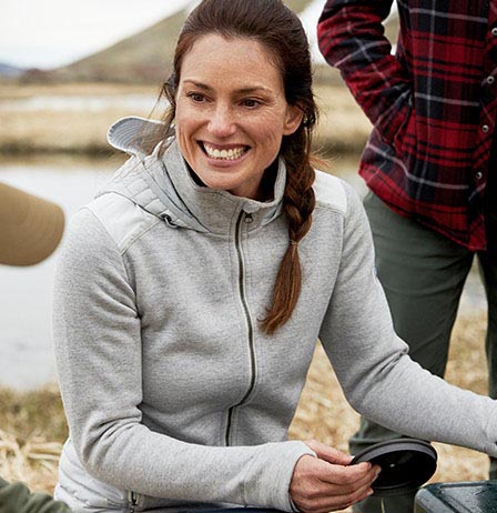 A woman smiling in KUHL women's cold weather fleece