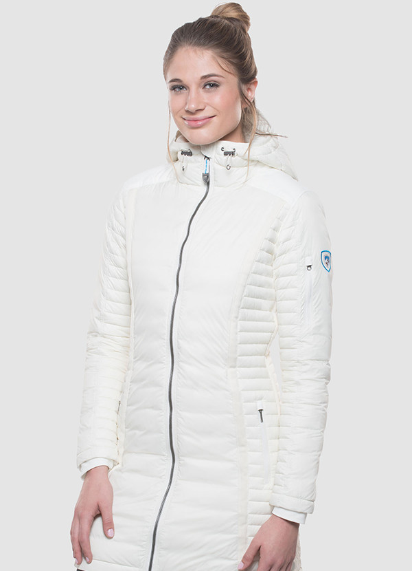 A studio photo of a woman wearing KUHL women's Spyfire Parka in Ivory Color